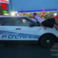 Detroit Police Car Drives Through Swarming Mob as Protesters Cling to Hood (Video)